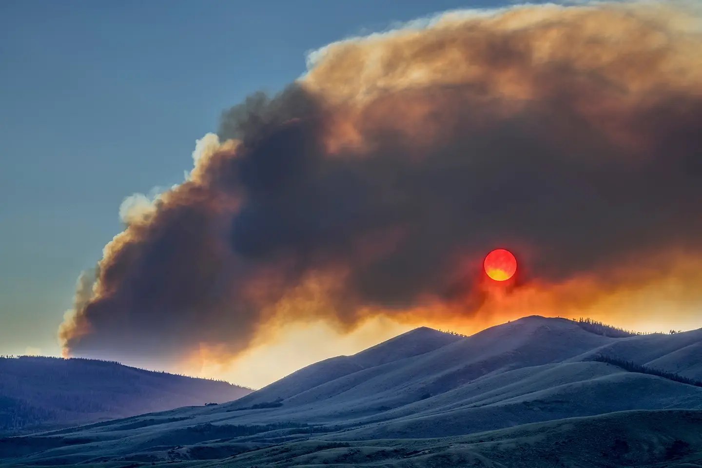 mountain smoke obscures the sun
