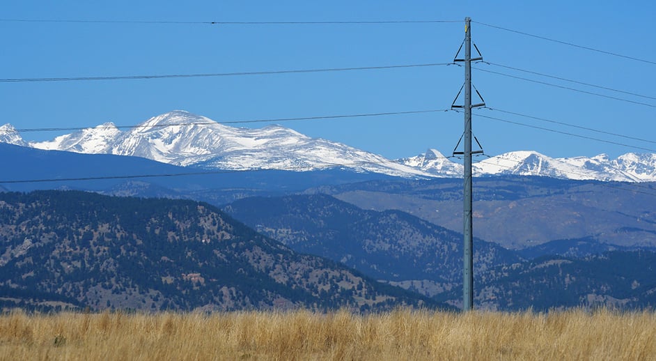 A utility pole stands out against the Colorado Rocky Mountains.