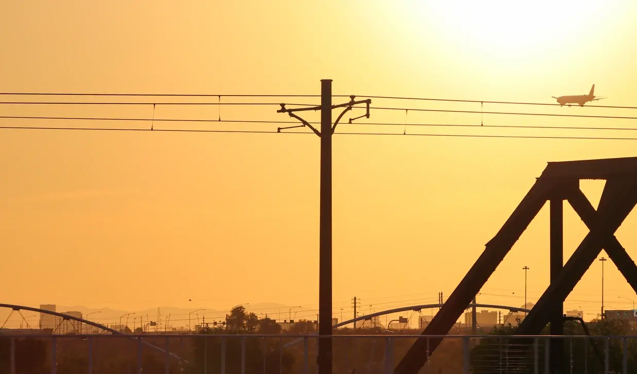 A smoky view of an orange sky near an Arizona airport
